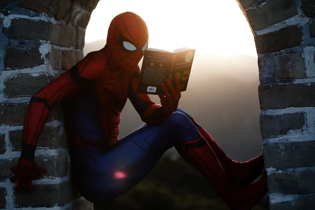 spiderman reads a book